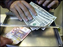 Money changer exchanges euros for dollars